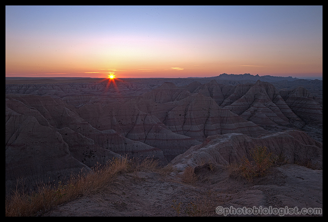 The sun breaking the horizon in the Badlands.